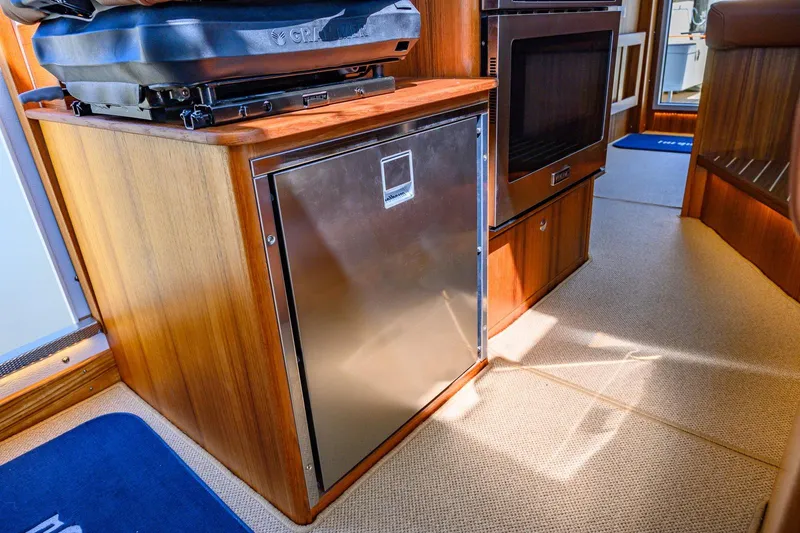 Slide: The Image of Interior of 2025 Targa 37 yacht featuring a compact kitchen area. - 13