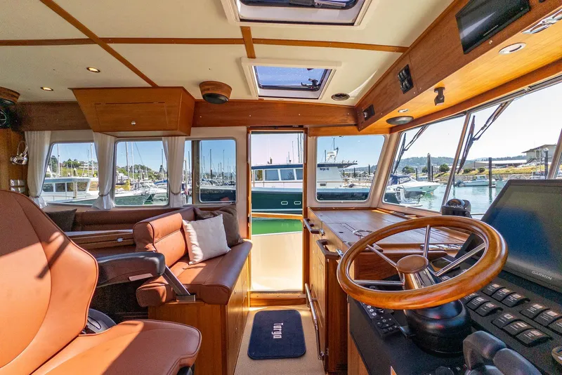 Slide: The Image of Interior of 2025 Targa 37 boat with wooden helm and leather seating. - 16