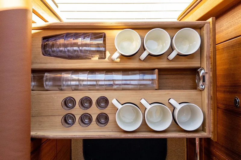Slide: The Image of Wooden drawer with neatly arranged cups and glasses in a Targa 37, 2025 model. - 18