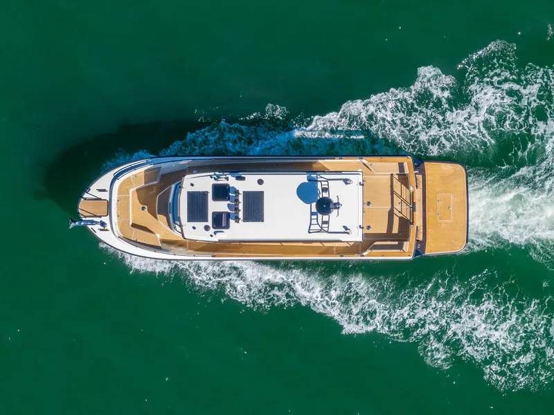 Slide: The Image of Aerial view of 2025 Targa 37 yacht cruising on green water. - 2