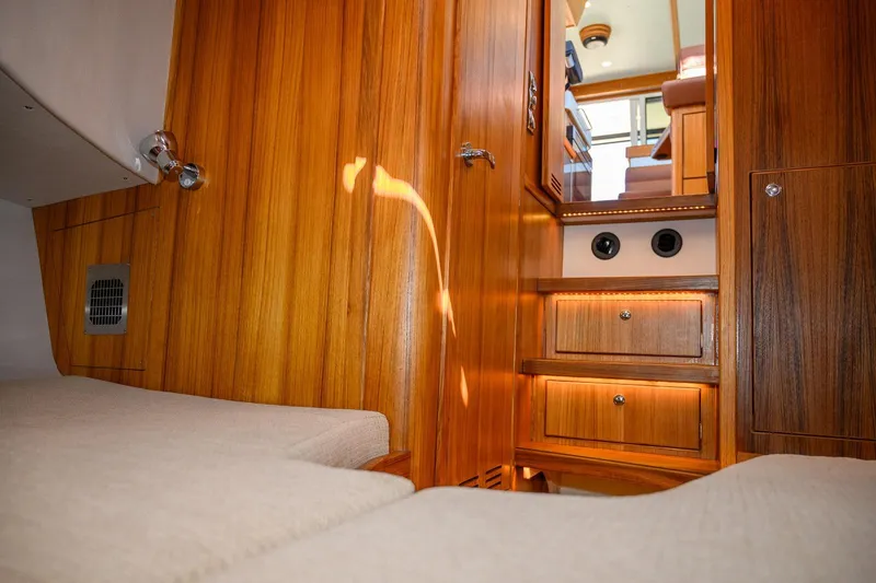 Slide: The Image of Interior of 2025 Targa 37 boat with wooden paneling and cozy cabin space. - 23