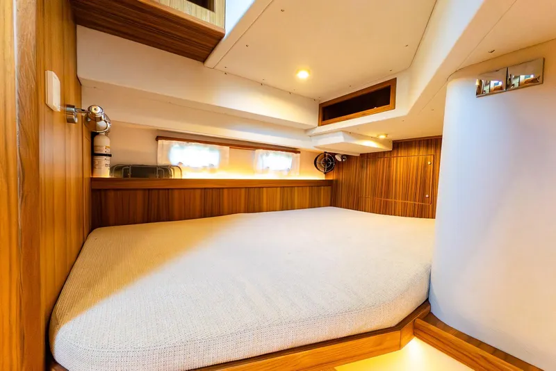 Slide: The Image of Luxurious cabin interior of 2025 Targa 37 yacht with wood paneling and cozy bed. - 29