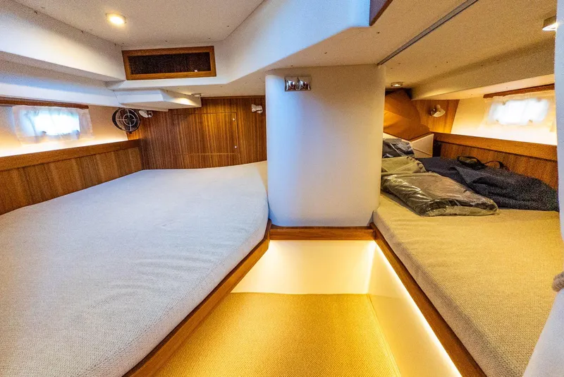 Slide: The Image of Luxurious 2025 Targa 37 yacht cabin with cozy twin beds and elegant wood paneling. - 30
