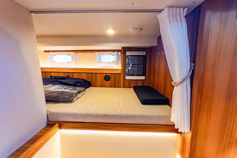 Slide: The Image of Luxurious cabin interior of 2025 Targa 37 yacht with cozy bed and elegant wood finish. - 31