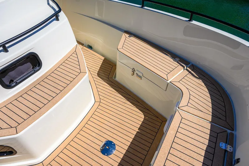 Slide: The Image of 2025 Targa 37 boat deck with teak flooring and storage compartment. - 35