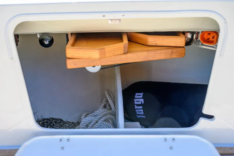 Slide: The Image of Storage compartment in a 2025 Targa 37 boat with ropes and wooden trays. - 39