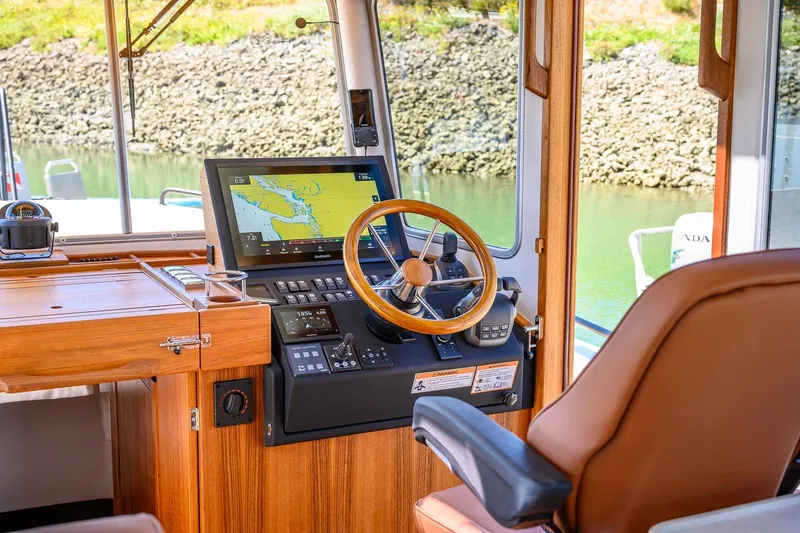 Slide: The Image of Interior of 2025 Targa 37 boat with navigation system and wooden steering wheel. - 5
