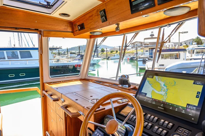 Slide: The Image of Interior view of 2025 Targa 37 boat cockpit with navigation system and marina background. - 7
