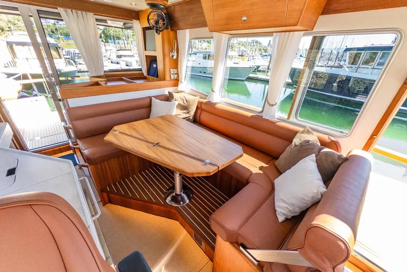 Slide: The Image of Luxurious interior of 2025 Targa 37 yacht with elegant seating and wooden table. - 9