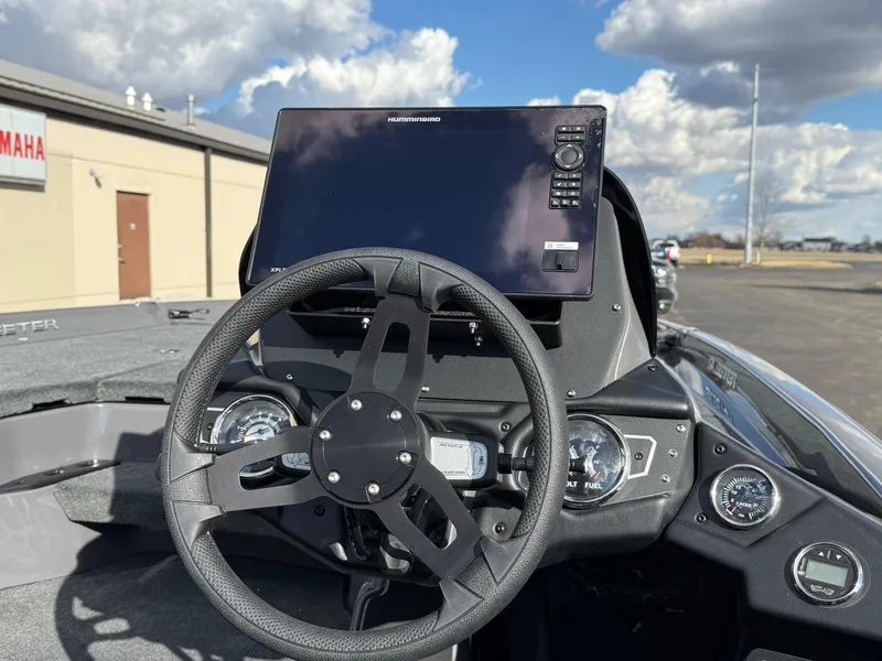 Slide: The Image of 2025 Skeeter ZXR21 boat dashboard with steering wheel and electronic display. - 12