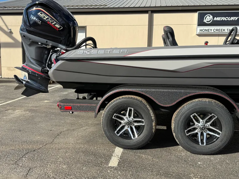 Slide: The Image of 2025 Skeeter ZXR21 boat with Yamaha engine on a dual-axle trailer. - 14