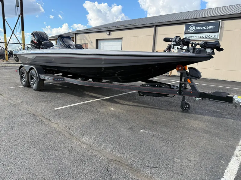 Slide: The Image of 2025 Skeeter ZXR21 boat on trailer, parked outside a building under a partly cloudy sky. - 3