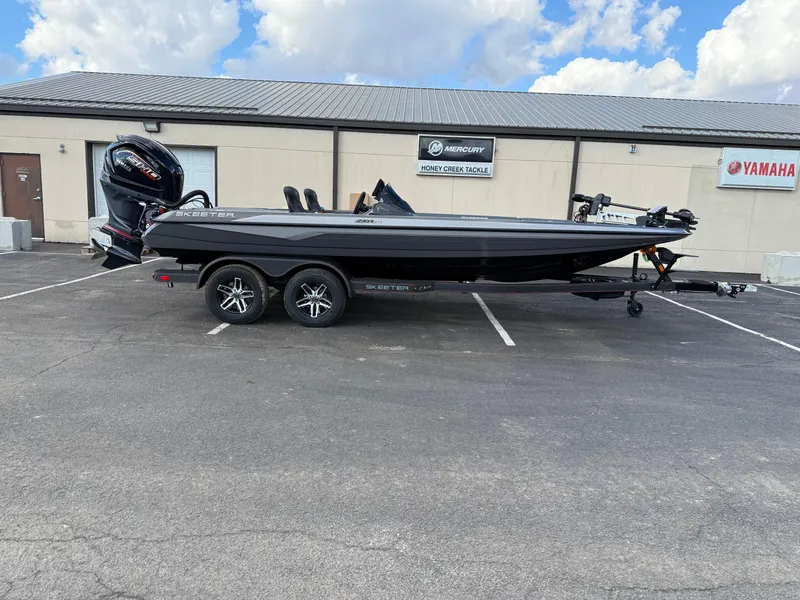 Slide: The Image of 2025 Skeeter ZXR21 boat on trailer in parking lot, Yamaha and Mercury signs visible. - 4