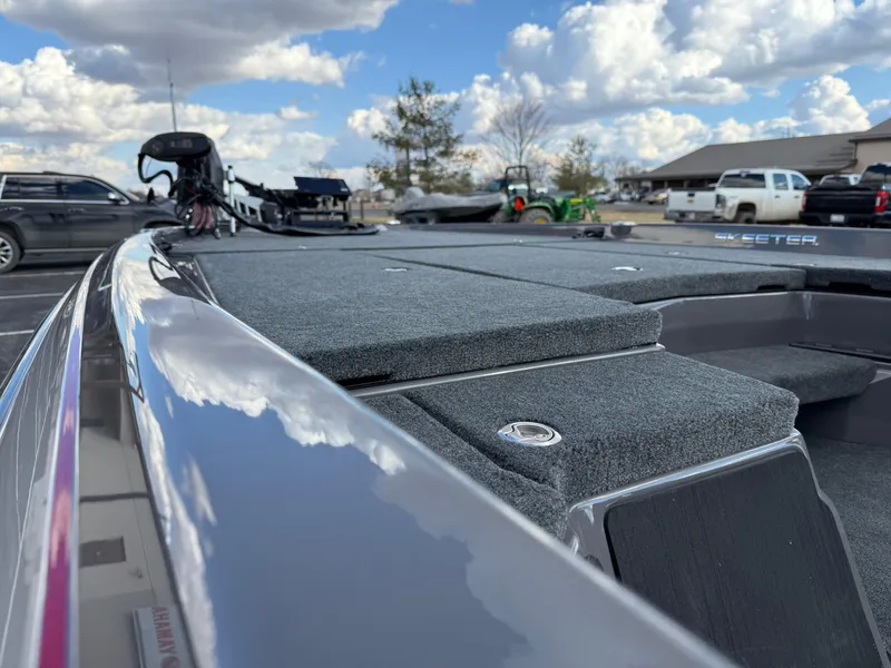 Slide: The Image of 2025 Skeeter ZXR21 boat deck with sleek design under a cloudy sky. - 7