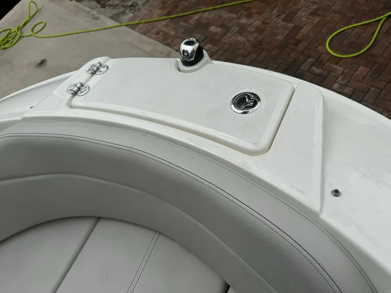 Slide: The Image of 2022 Sea Ray SPX 230 OB boat's white seating and storage compartment. - 10