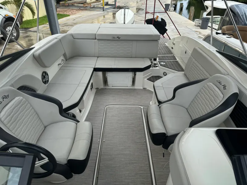 Slide: The Image of 2022 Sea Ray SPX 230 OB boat interior with spacious seating and modern design. - 11