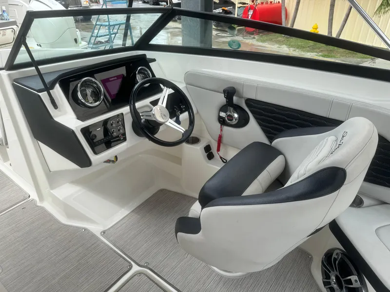 Slide: The Image of 2022 Sea Ray SPX 230 OB boat cockpit with steering wheel and control panel. - 12