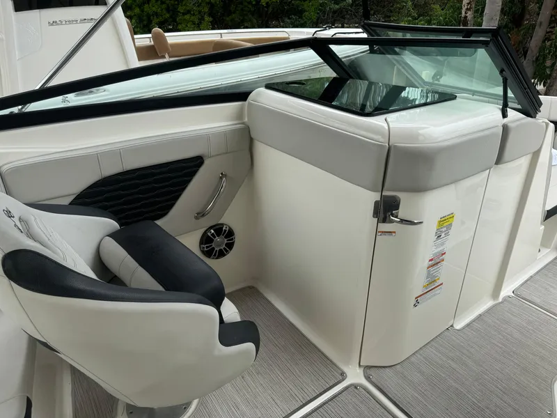 Slide: The Image of 2022 Sea Ray SPX 230 OB boat interior with seating and dashboard. - 14