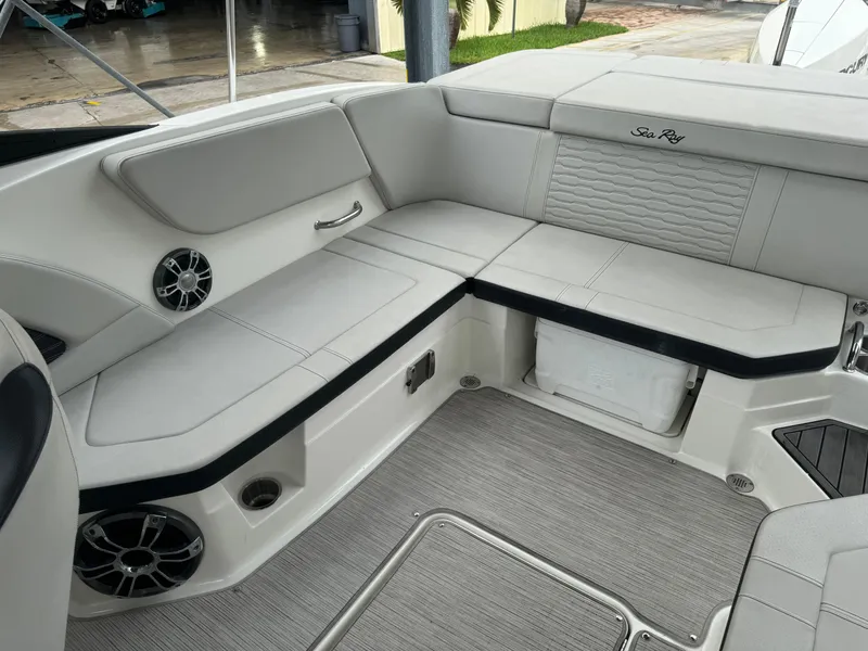 Slide: The Image of 2022 Sea Ray SPX 230 OB boat interior with cushioned seating and speakers. - 16