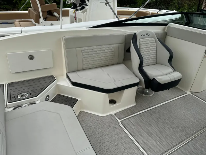 Slide: The Image of 2022 Sea Ray SPX 230 OB boat interior with cushioned seating and modern design. - 19