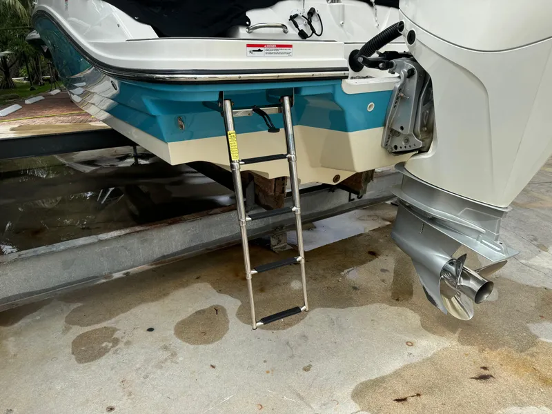 Slide: The Image of 2022 Sea Ray SPX 230 OB boat with ladder and outboard motor. - 21