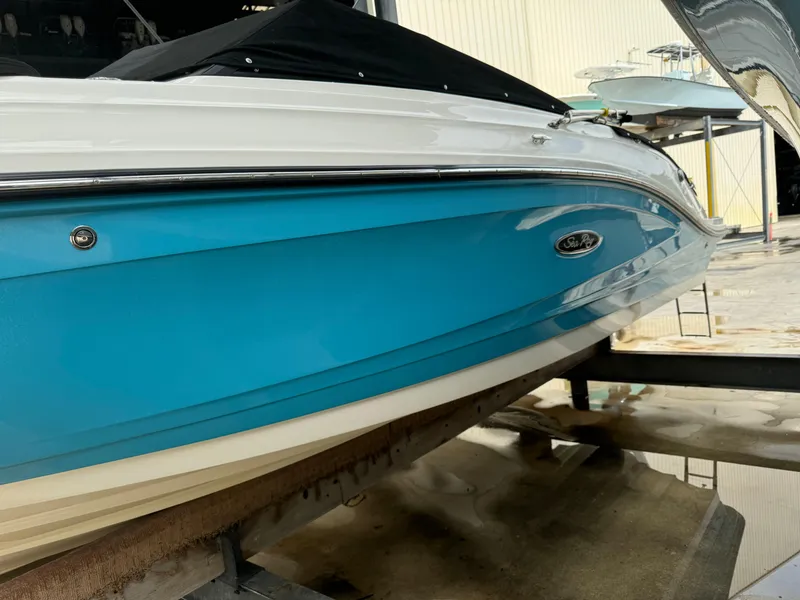 Slide: The Image of 2022 Sea Ray SPX 230 OB boat with blue hull on display. - 4