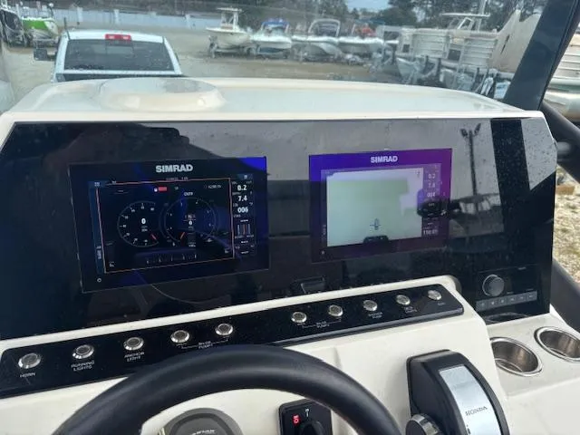 Slide: The Image of Dashboard of 2022 Brig Navigator 24 with Simrad navigation displays. - 19