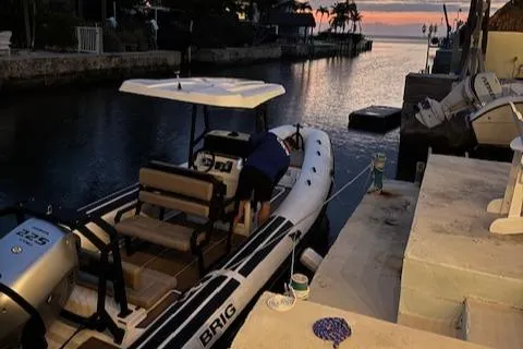 Slide: The Image of 2022 Brig Navigator 24 boat docked at sunset in a serene canal setting. - 29