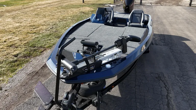 Slide: The Image of 2025 iKon VLX21 fishing boat on trailer, parked on paved road. - 11