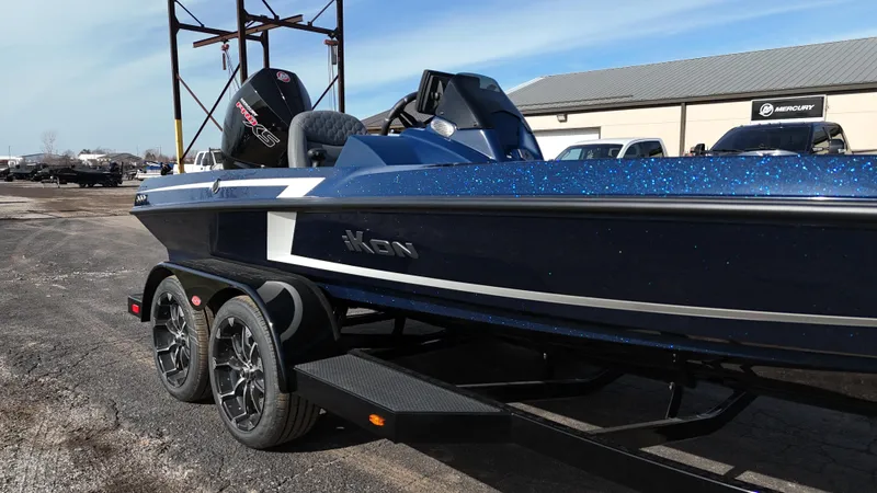 Slide: The Image of 2025 iKon VLX21 boat on trailer, blue exterior, parked outdoors. - 8