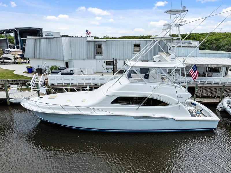 Slide: The Image of 2003 Bertram 570 Moppie yacht docked at marina, side view. - 1