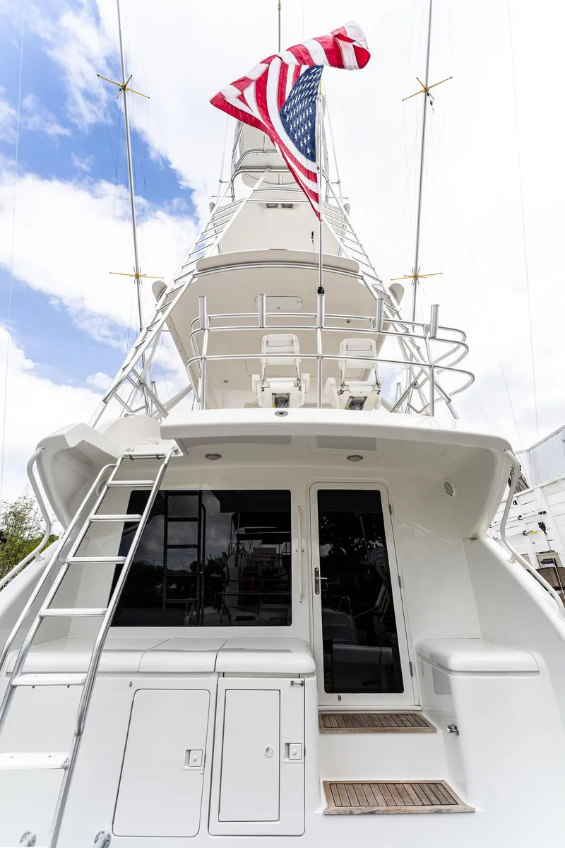 Slide: The Image of 2003 Bertram 570 Moppie yacht with American flag, viewed from the stern. - 11