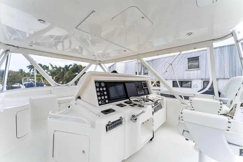 Slide: The Image of 2003 Bertram 570 Moppie yacht cockpit with modern navigation equipment and seating. - 13