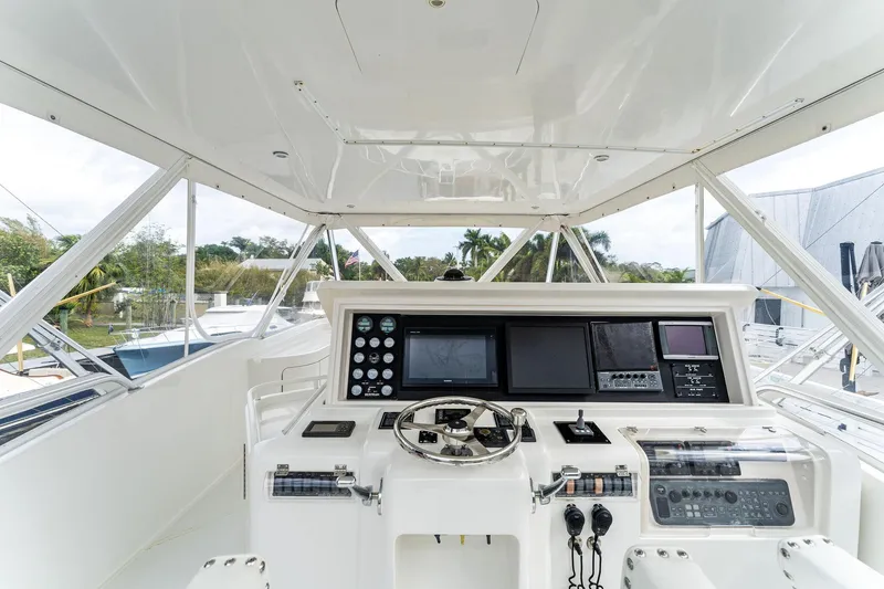 Slide: The Image of 2003 Bertram 570 Moppie yacht helm with advanced navigation controls and sleek design. - 14