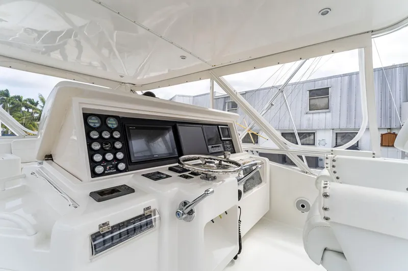 Slide: The Image of 2003 Bertram 570 Moppie yacht helm with modern controls and navigation equipment. - 17