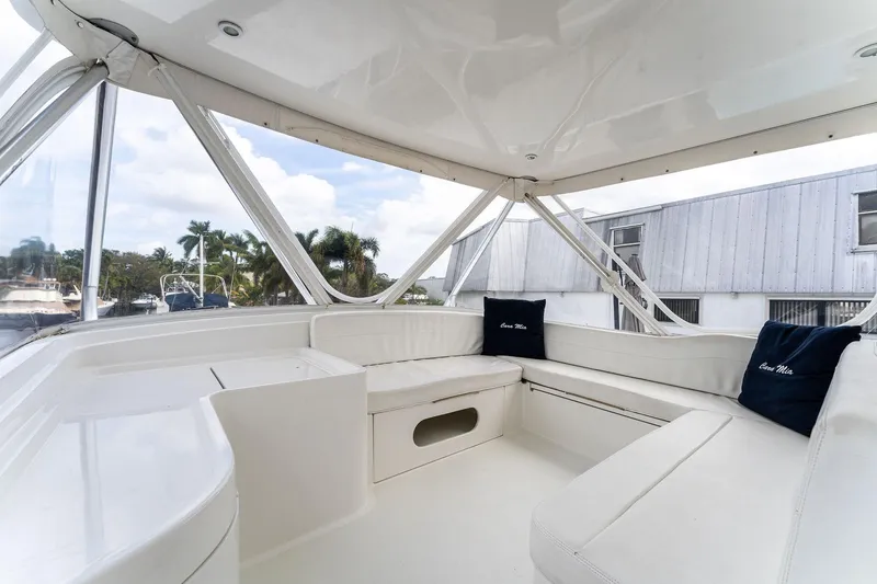 Slide: The Image of 2003 Bertram 570 Moppie yacht interior with white seating and cushions. - 18