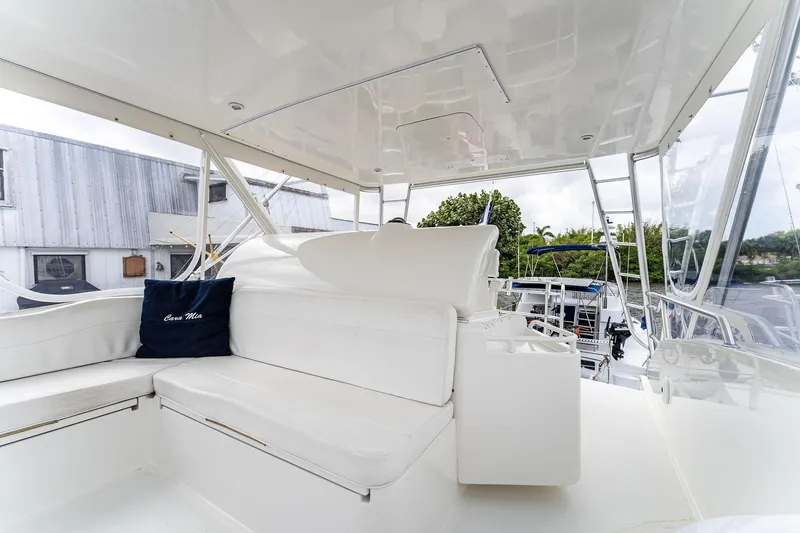 Slide: The Image of 2003 Bertram 570 Moppie yacht interior with white seating and nautical decor. - 19
