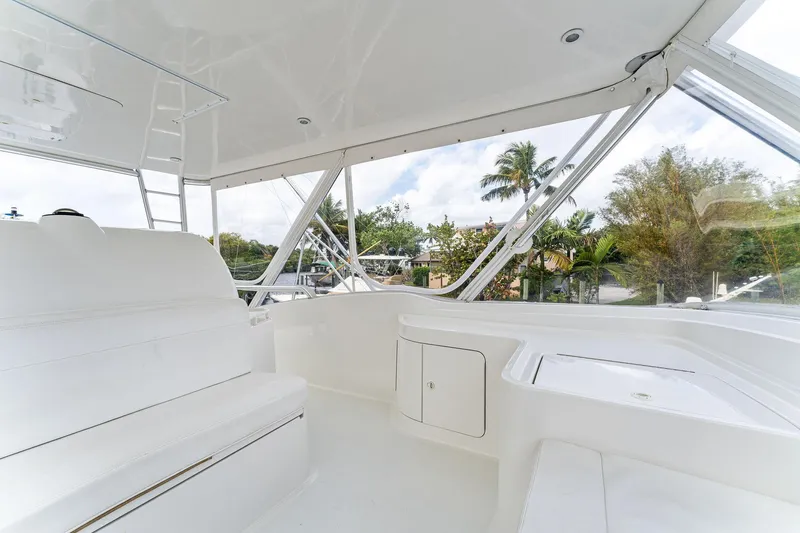 Slide: The Image of 2003 Bertram 570 Moppie yacht interior with white seating and panoramic windows. - 20