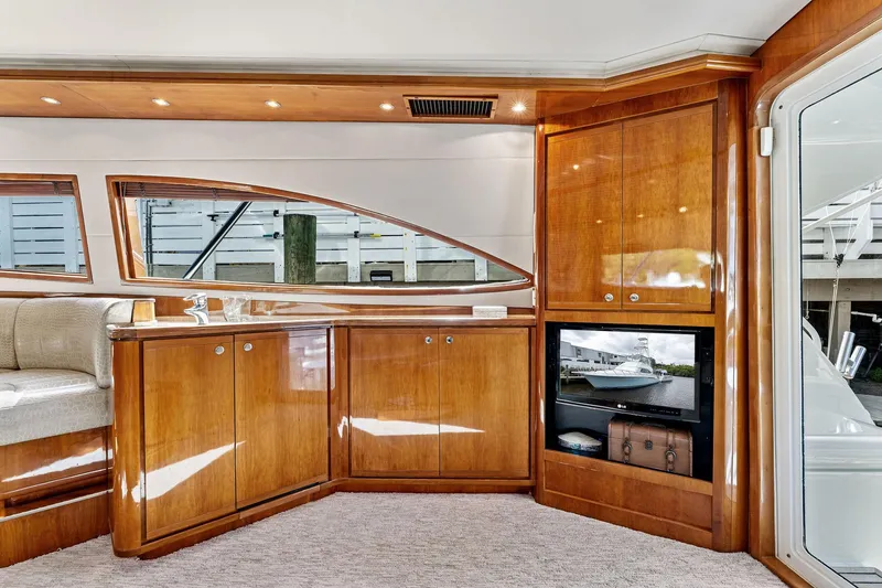 Slide: The Image of Luxurious interior of 2003 Bertram 570 Moppie yacht with polished wood cabinetry. - 26
