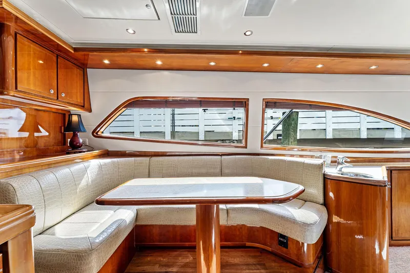 Slide: The Image of Luxurious interior of 2003 Bertram 570 Moppie yacht with elegant wood finishes and seating area. - 29
