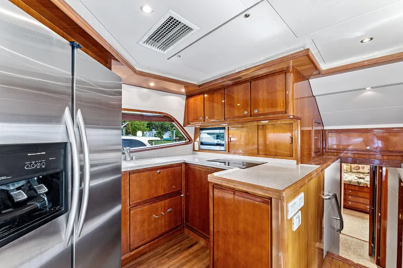 Slide: The Image of Luxurious kitchen interior of 2003 Bertram 570 Moppie yacht with wooden cabinetry and stainless steel appliances. - 31