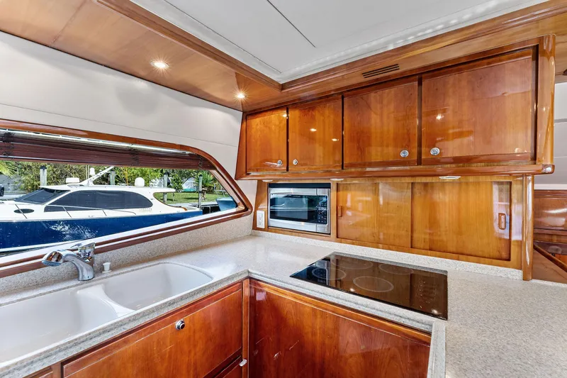 Slide: The Image of Luxurious kitchen interior of 2003 Bertram 570 Moppie yacht with wood cabinetry and modern appliances. - 33