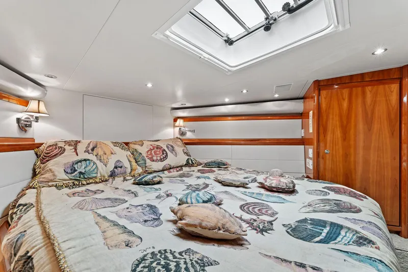 Slide: The Image of Luxurious cabin interior of 2003 Bertram 570 Moppie yacht with seashell-themed bedding. - 35