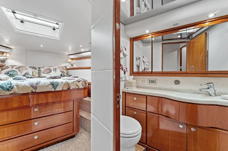 Slide: The Image of Luxurious interior of 2003 Bertram 570 Moppie yacht featuring bedroom and bathroom. - 39