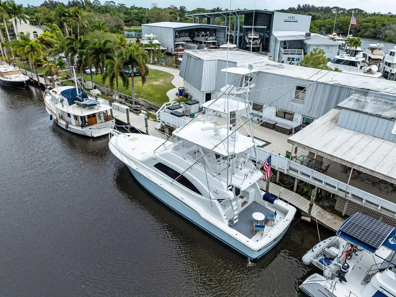 Slide: The Image of Aerial view of a 2003 Bertram 570 Moppie yacht docked at a marina. - 4