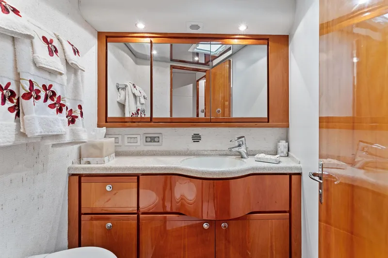 Slide: The Image of Luxurious bathroom in 2003 Bertram 570 Moppie yacht with wooden cabinetry and floral towels. - 40