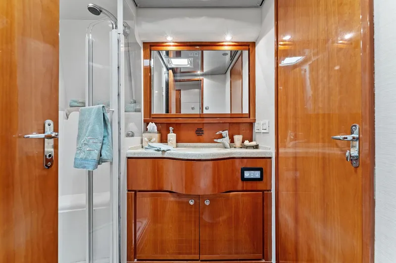 Slide: The Image of Luxurious bathroom interior of 2003 Bertram 570 Moppie yacht with wooden cabinetry and modern fixtures. - 42
