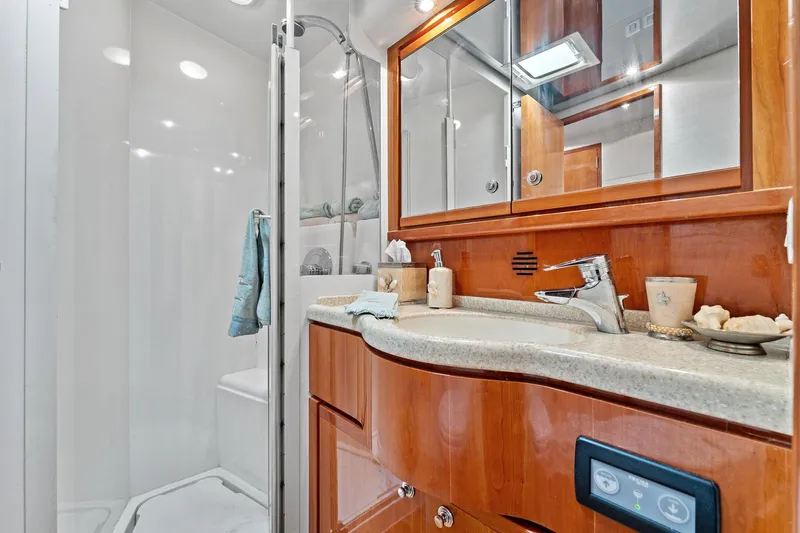 Slide: The Image of Luxurious bathroom in 2003 Bertram 570 Moppie yacht with modern fixtures and wooden cabinetry. - 43