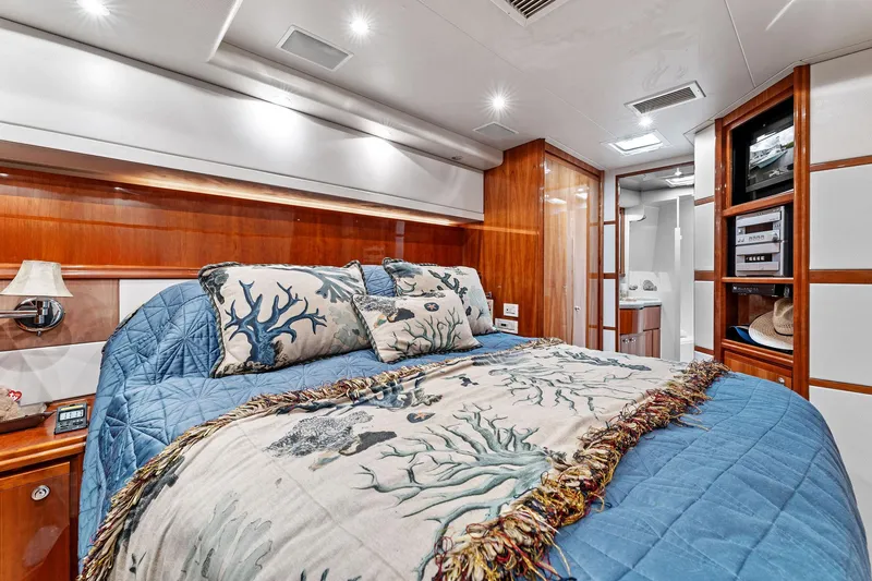 Slide: The Image of Luxurious cabin interior of 2003 Bertram 570 Moppie yacht with elegant bedding and wood accents. - 47