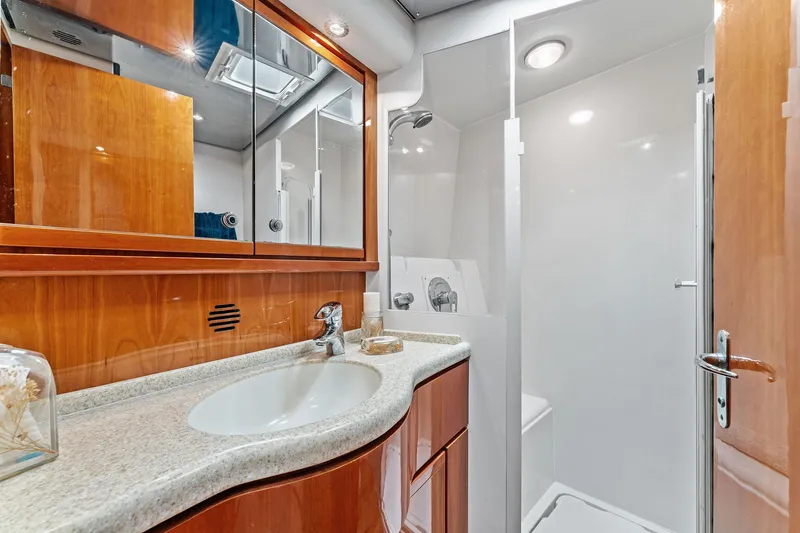 Slide: The Image of Luxurious bathroom interior of 2003 Bertram 570 Moppie yacht with wooden cabinetry and modern fixtures. - 49